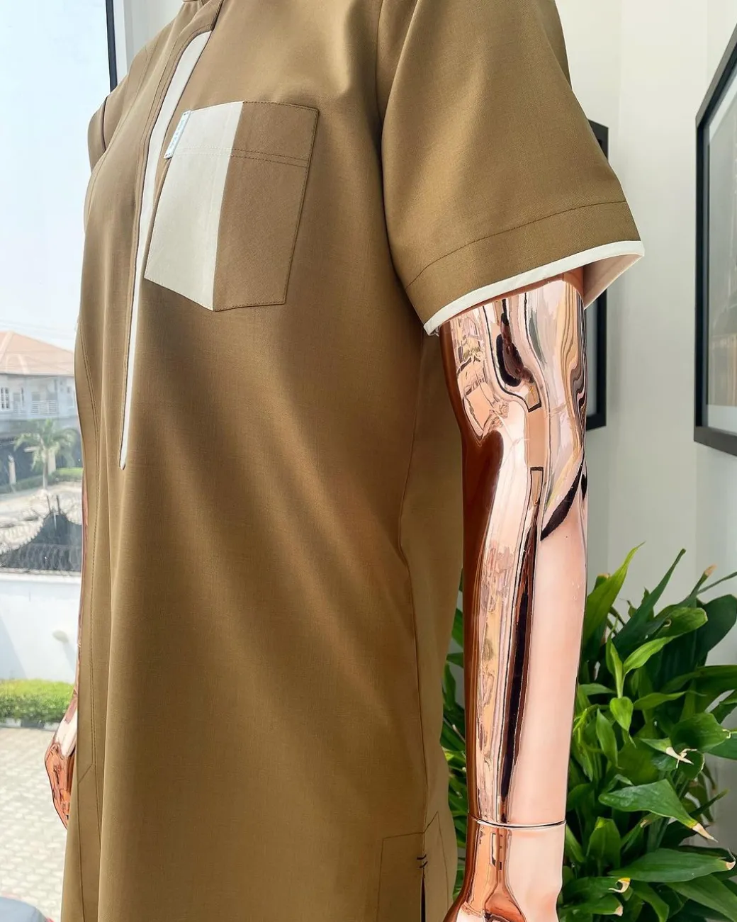 A bishop neck, Peanut and almond cream mix, clear view Swarovski button with layered flap and pocket detailing african traditional senator kaftan native.