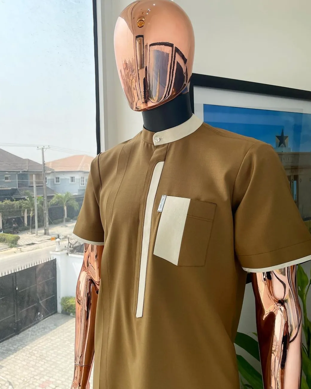 A bishop neck, Peanut and almond cream mix, clear view Swarovski button with layered flap and pocket detailing african traditional senator kaftan native.
