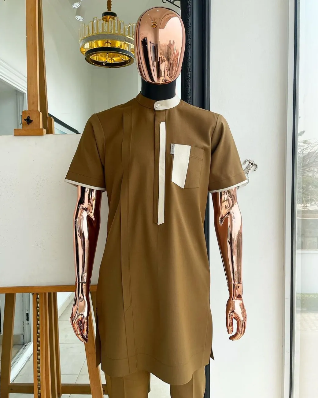 A bishop neck, Peanut and almond cream mix, clear view Swarovski button with layered flap and pocket detailing african traditional senator kaftan native.