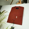 A black stripe and burnt orange African kaftan with gold buttons detailing and sokoto