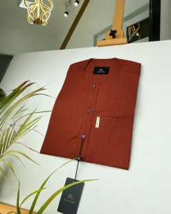 A black stripe and burnt orange African kaftan with gold buttons detailing and sokoto