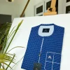 A blue and ivory check kaftan with front flap detailing and sokoto