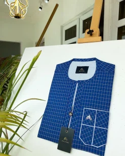 A blue and ivory check kaftan with front flap detailing and sokoto