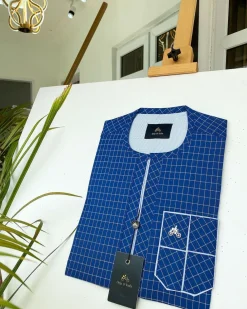A blue and ivory check kaftan with front flap detailing and sokoto