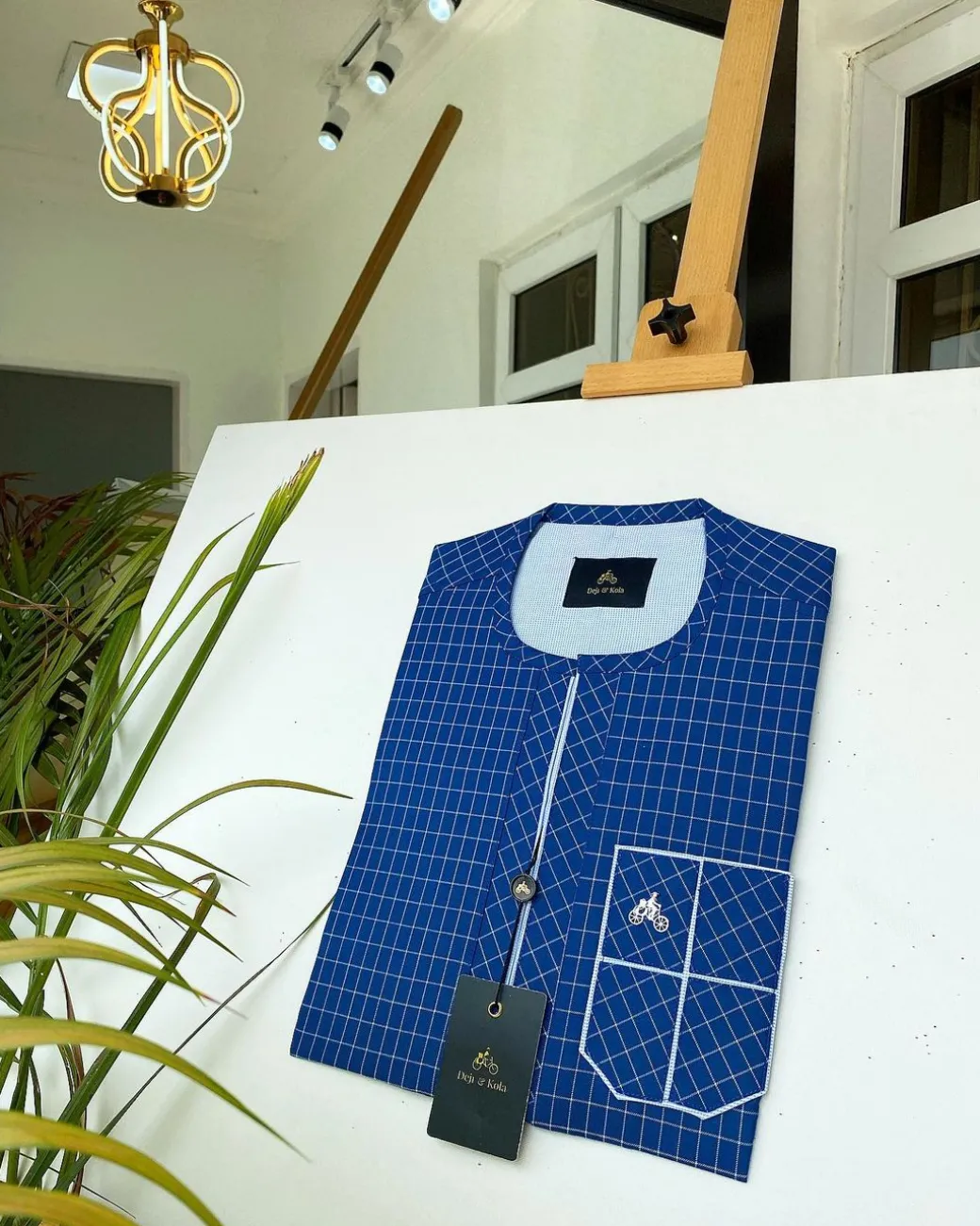 A blue and ivory check kaftan with front flap detailing and sokoto