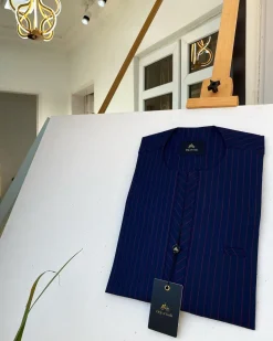 A blue and red stripe kaftan, interlocking neck piping