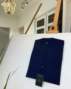 A blue and red stripe kaftan, interlocking neck piping