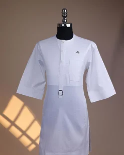 A Bright white, front flap with Swarovski button & metal tag details, 3/4 sleeve African kaftan.