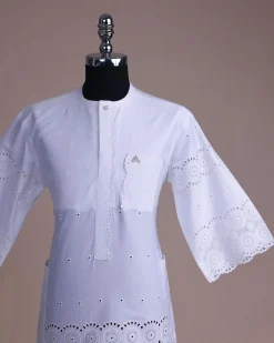 A bright white, Swiss patterned lace, front flap with left side pattern, Swarovski button, 3/4 sleeve African kaftan.