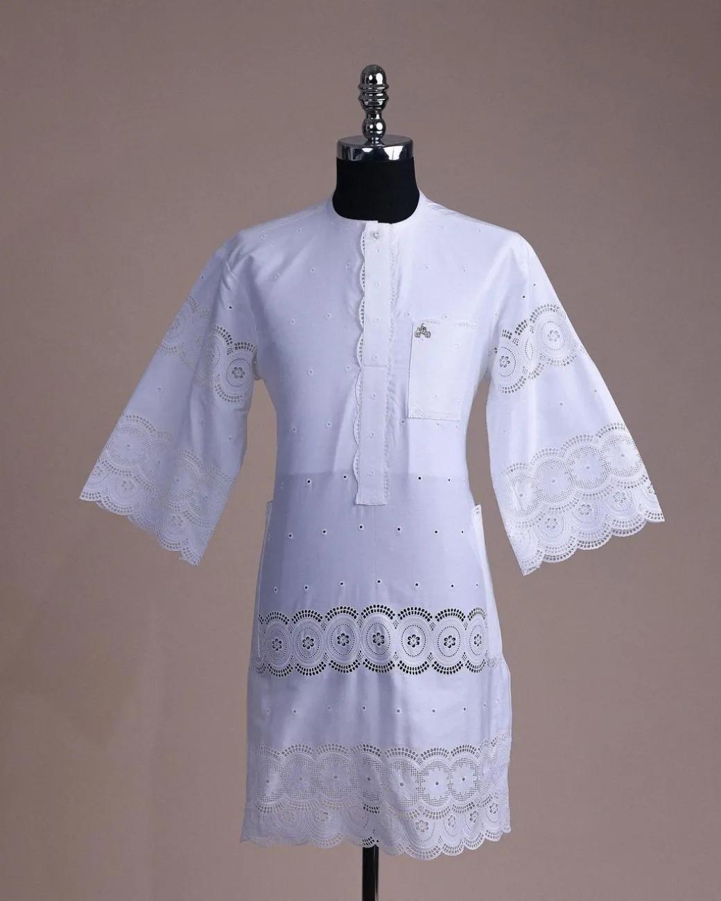 A bright white, Swiss patterned lace, front flap with side pattern, Swarovski button, 3/4 sleeve African kaftan native.