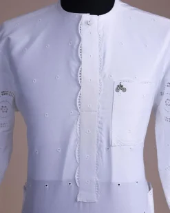 A bright white, Swiss patterned lace, front flap with side pattern, Swarovski button, 3/4 sleeve African kaftan native.
