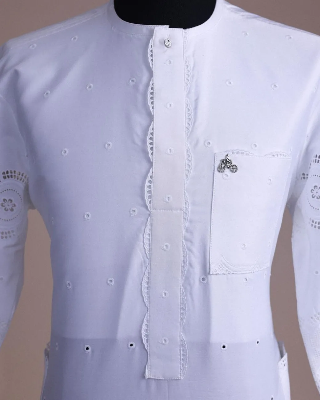 A bright white, Swiss patterned lace, front flap with side pattern, Swarovski button, 3/4 sleeve African kaftan native.