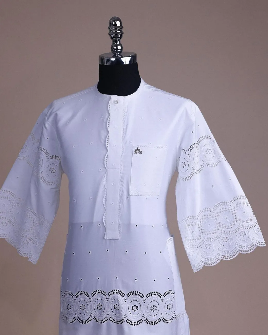 A bright white, Swiss patterned lace, front flap with side pattern, Swarovski button, 3/4 sleeve African kaftan native.
