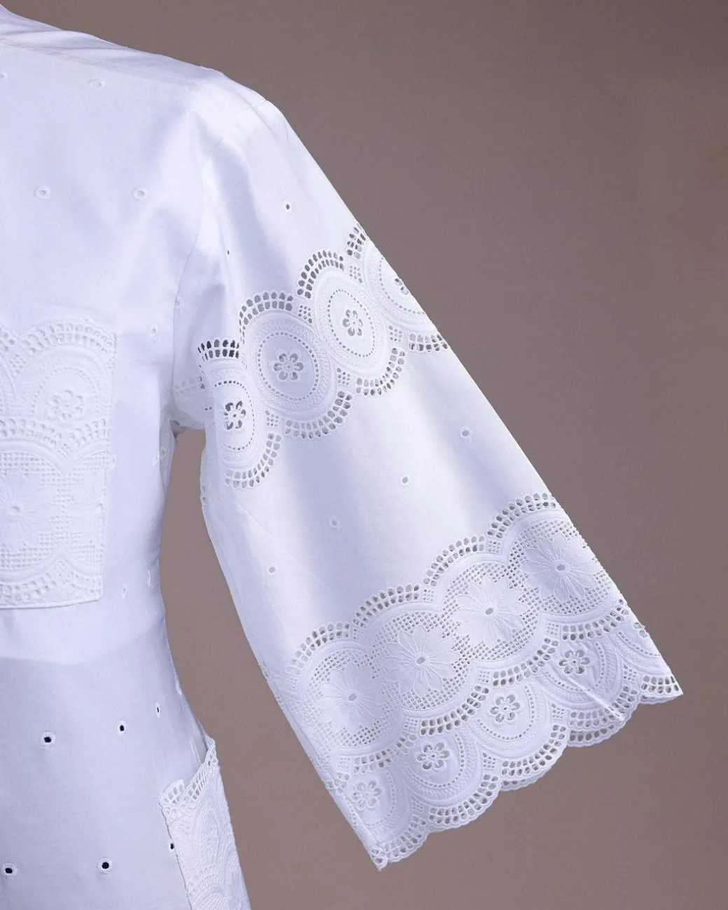 A bright white, Swiss patterned lace, front flap, 3/4 sleeve African kaftan native.