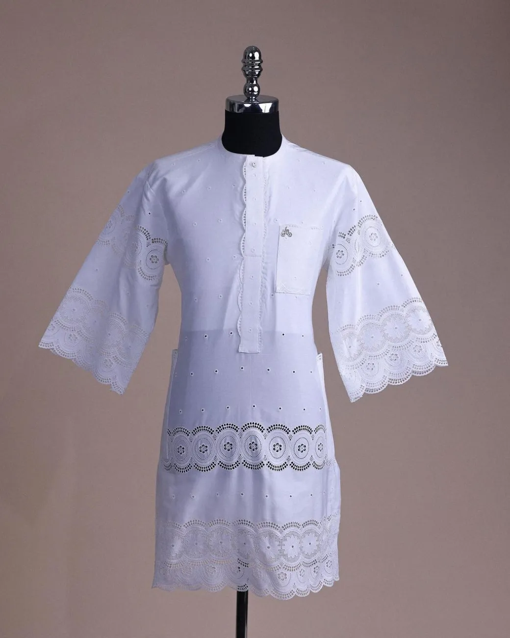 A bright white, Swiss patterned lace, front flap with side pattern, Swarovski button, 3/4 sleeve African kaftan native.