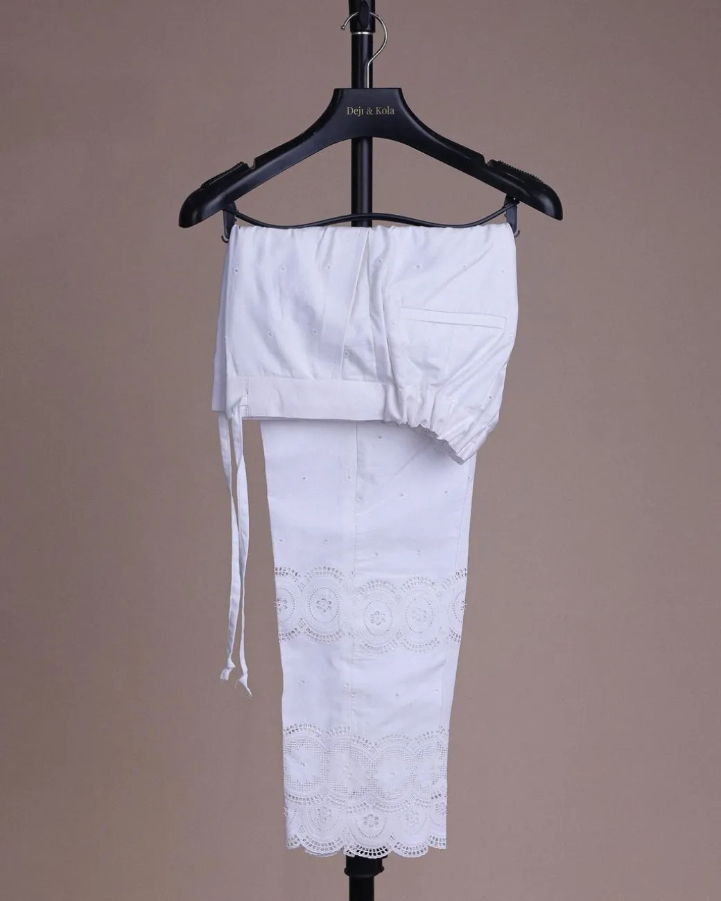 A bright white, Swiss patterned lace, front flap with side pattern, Swarovski button, 3/4 sleeve African kaftan native.
