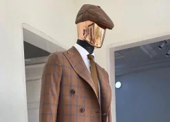 A brown and blue windowpane check papas hat.