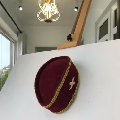 A Burgundy and Gold Ceremonial African Traditional Hat