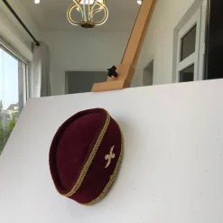 A Burgundy and Gold Ceremonial African Traditional Hat
