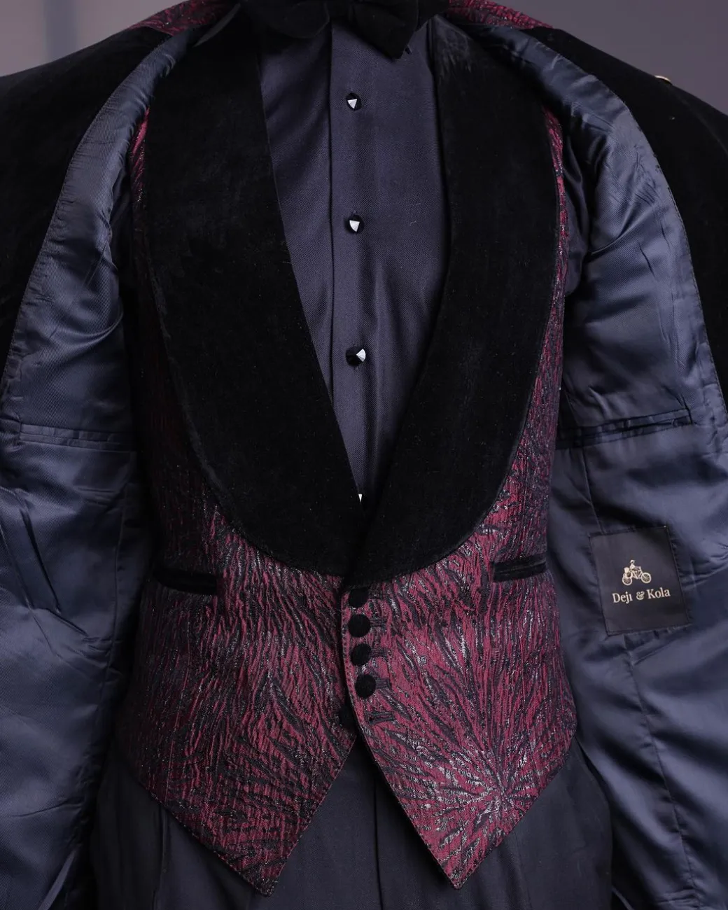 A burgundy, black broom splashed metallic jacquard, knitted, peak lapel tuxedo suit