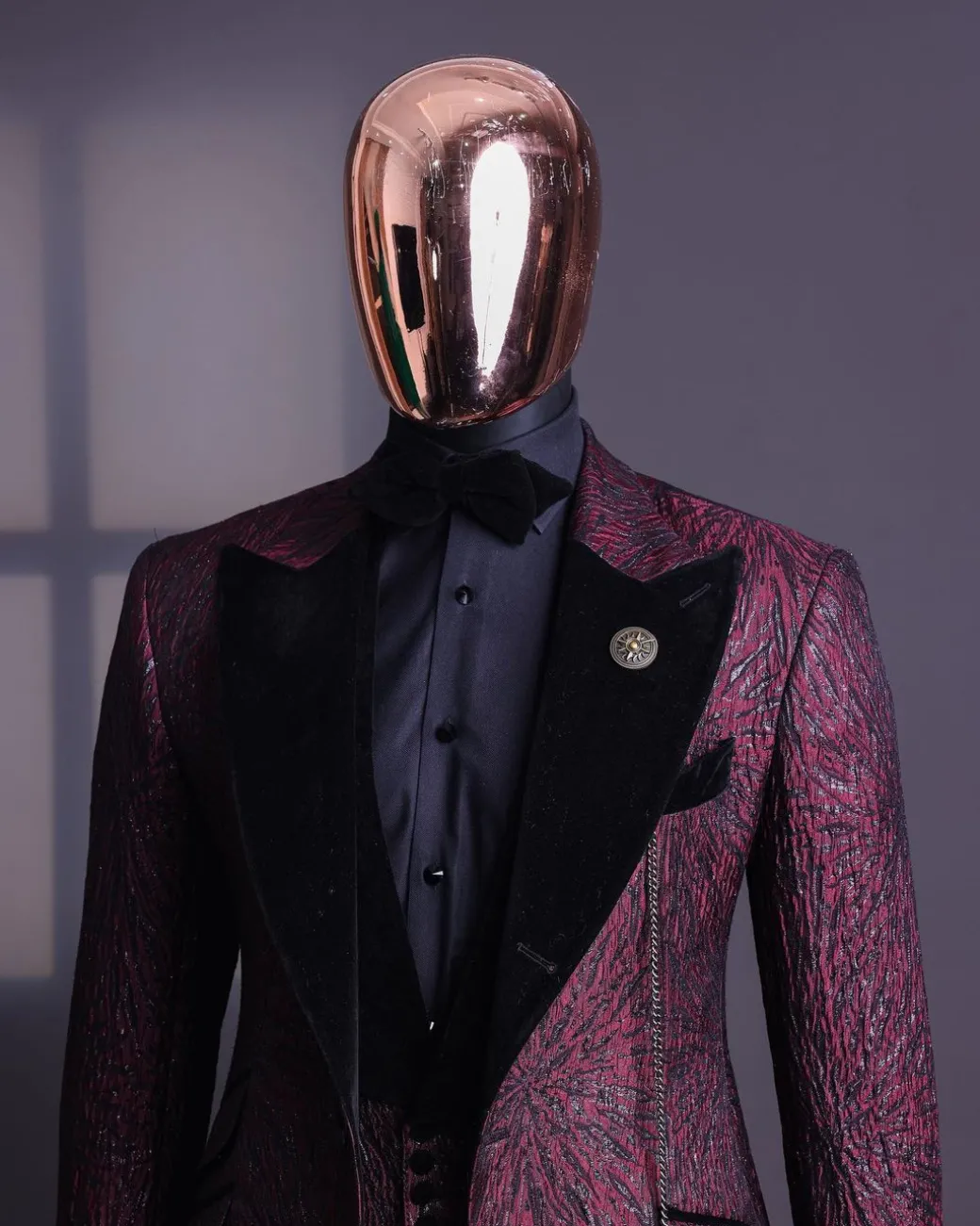 A burgundy, black broom splashed metallic jacquard, knitted, peak lapel tuxedo suit