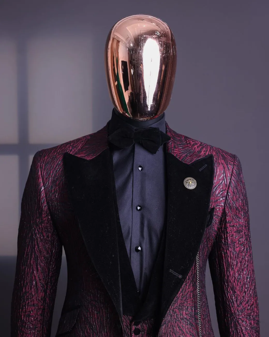 A burgundy, black broom splashed metallic jacquard, knitted, peak lapel tuxedo suit