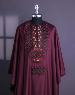 A Burgundy, Connected Ring With Gold Eyelet Details Agbada