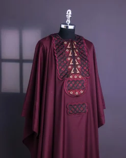A Burgundy, Connected Ring With Gold Eyelet Details Agbada