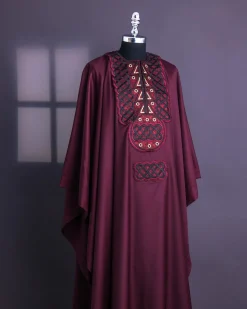 A Burgundy, Connected Ring With Gold Eyelet Details Agbada
