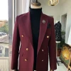 A Burgundy Double Breasted peak lapel with Gold Button suit