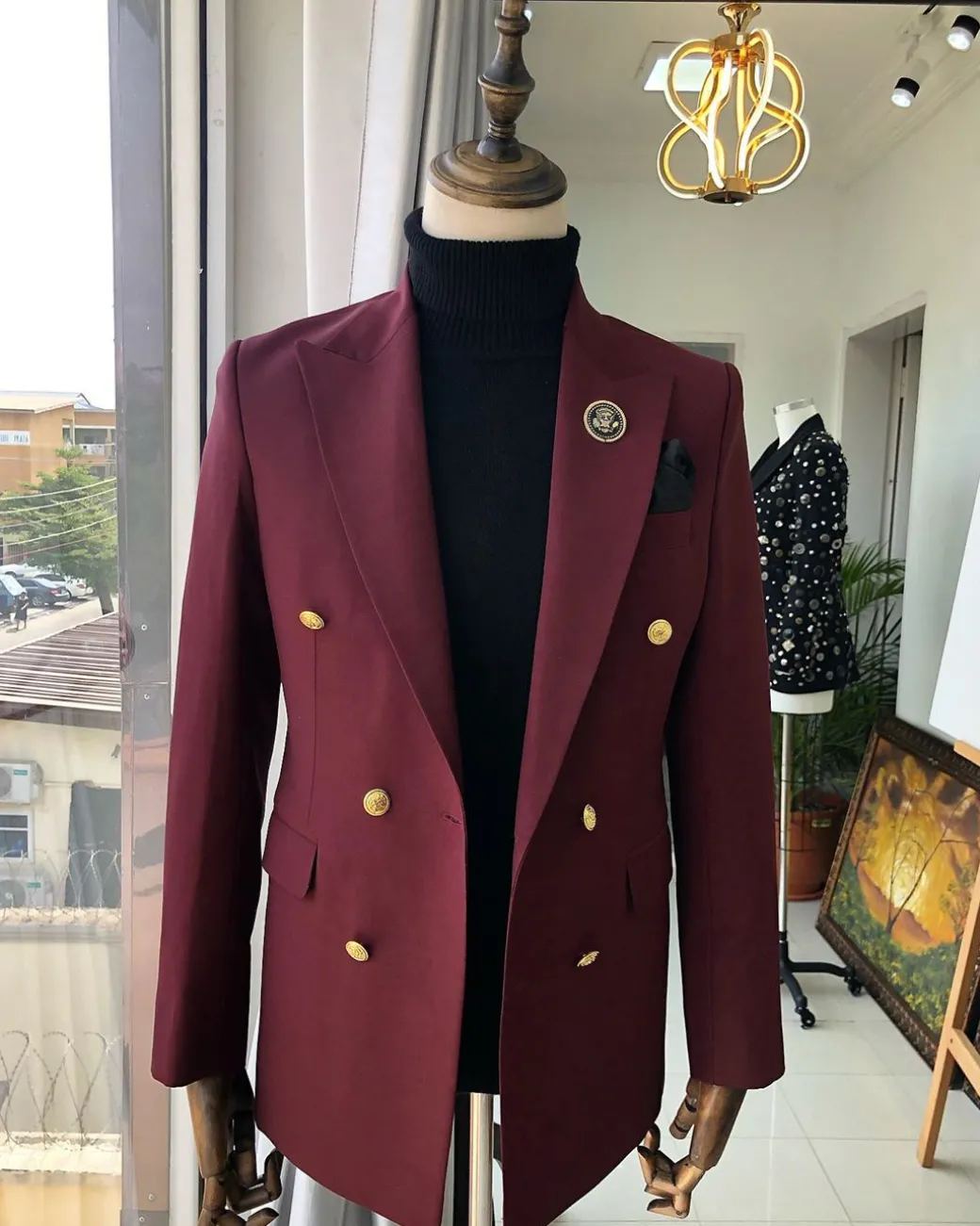 A Burgundy Double Breasted peak lapel with Gold Button suit