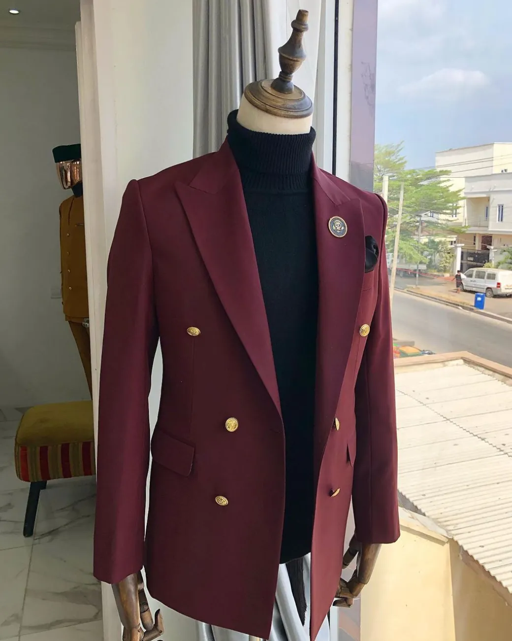 A Burgundy Double Breasted peak lapel with Gold Button suit