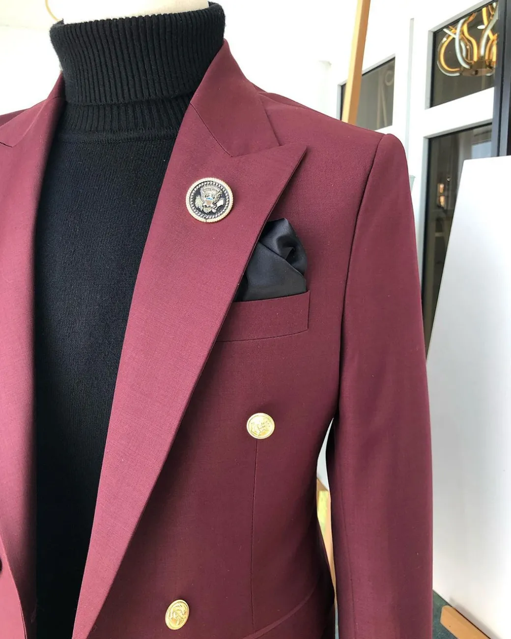A Burgundy Double Breasted peak lapel with Gold Button suit
