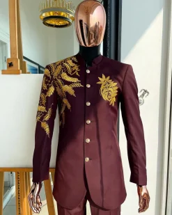 A burgundy safari suit with gold floral pattern embroidery detailing