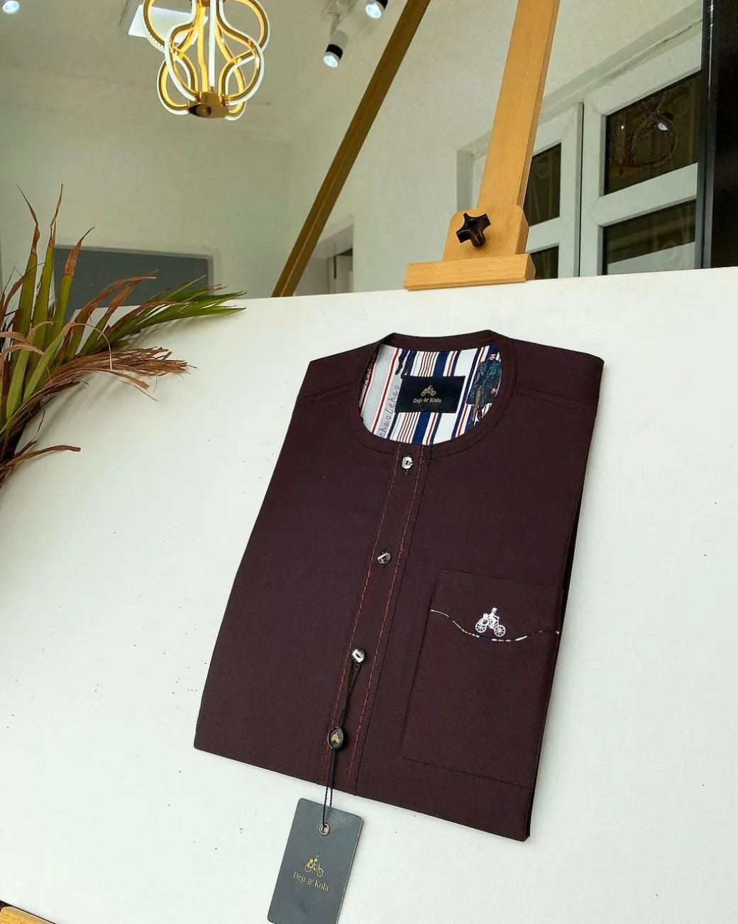 A burgundy with Swarovski button details African kaftan