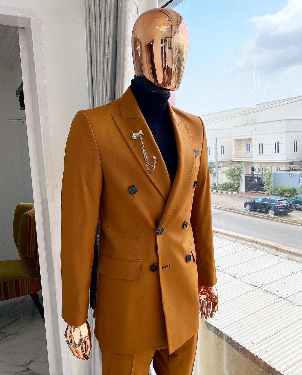 A Burnt Orange Double Breasted Peak Lapel Suit.