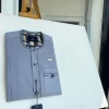A cadet grey patch pocket and a front flap with a clear view of Swarovski button detail traditional Senator Kaftan native