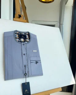 A cadet grey patch pocket and a front flap with a clear view of Swarovski button detail traditional Senator Kaftan native