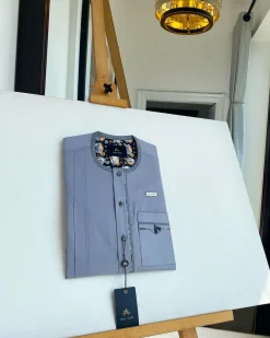 A cadet grey patch pocket and a front flap with a clear view of Swarovski button detail traditional Senator Kaftan native