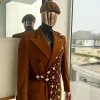 A Caramel brown, soaked velvet, peak lapel double breasted trench suit
