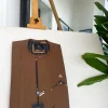 A caramel brown strap and roof pocket, a single button front flap African traditional senator kaftan native.