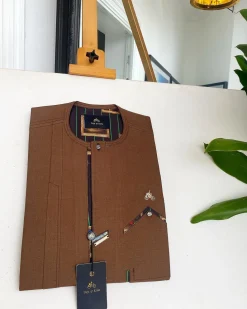 A caramel brown strap and roof pocket, a single button front flap African traditional senator kaftan native.