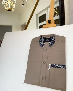 A Carton brown African kaftan with paisley details, Swarovski buttons and sokoto