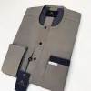 A Carton-colored kaftan with a clear view of black Swarovski button detailing and sokoto