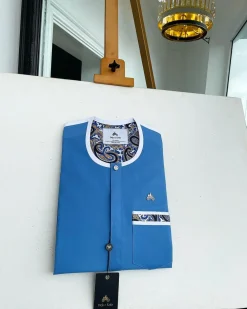 A cerulean blue, vertical flap with horizontal paisley patch pocket detailing and a Swarovski button African traditional senator kaftan native