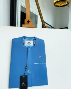 A cerulean blue, vertical Flap with Swarovski button on flap, related embroidery detailing African traditional senator kaftan native.