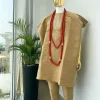 A champagne gold aso oke dashiki, with a floral and ancient style shaped embroidery design, hand woven Yoruba hat, an extra length red and gold coral bead.