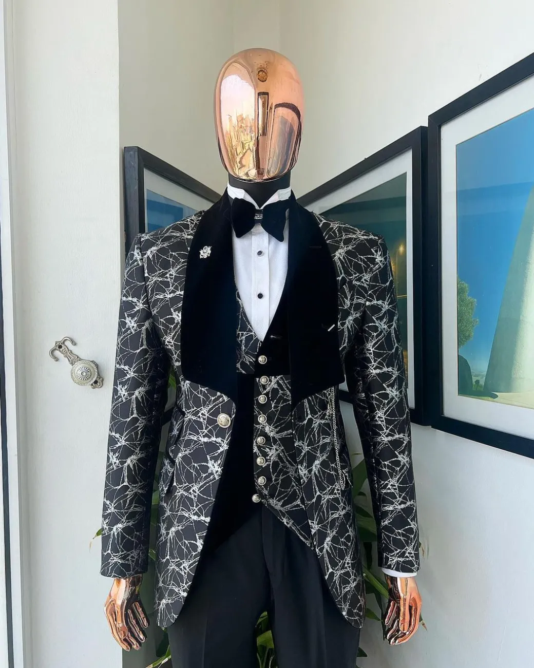 A charcoal black and silver spiral jacquard, shawl lapel tuxedo suit
