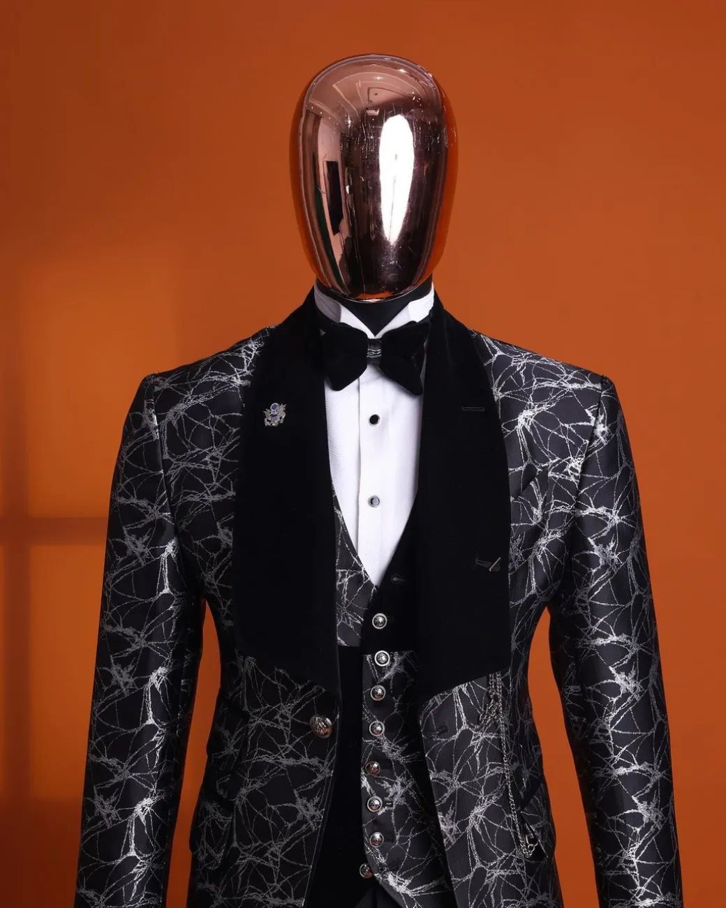 A charcoal black and silver spiral jacquard, shawl lapel tuxedo suit