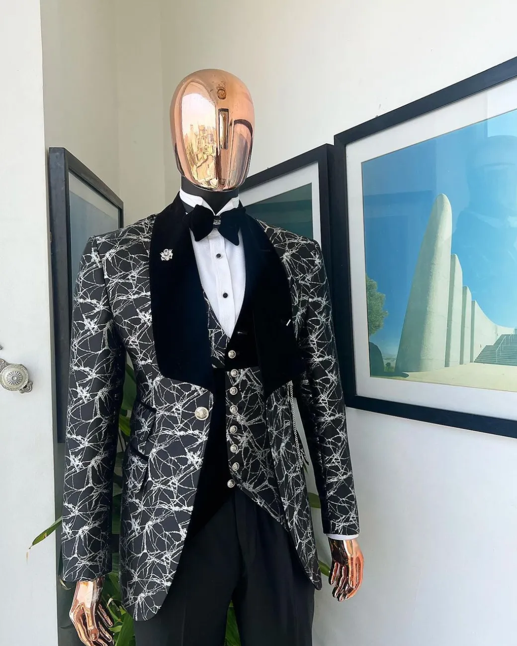 A charcoal black and silver spiral jacquard, shawl lapel tuxedo suit